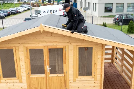 Verlegung von Dachpappe auf dem Holzhaus
